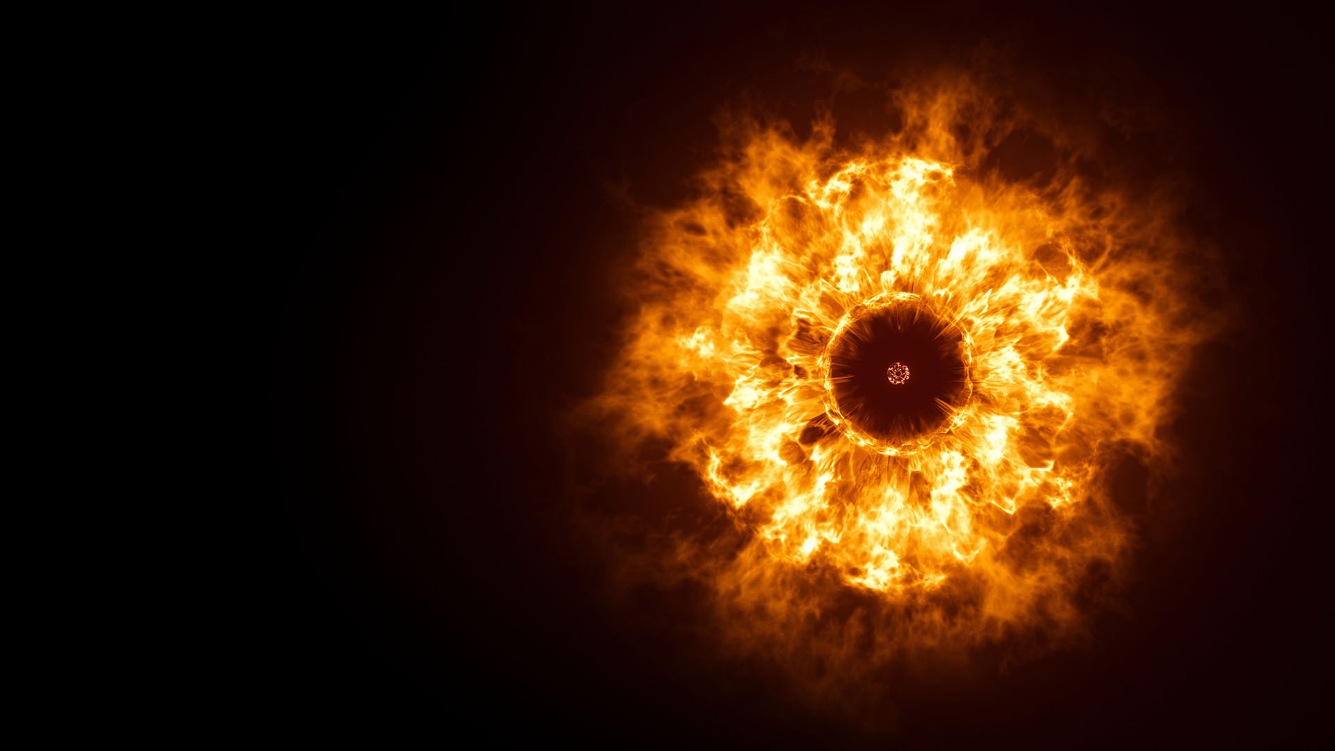 Bright fiery ring with a dark center, resembling a solar phenomenon, against a black background.