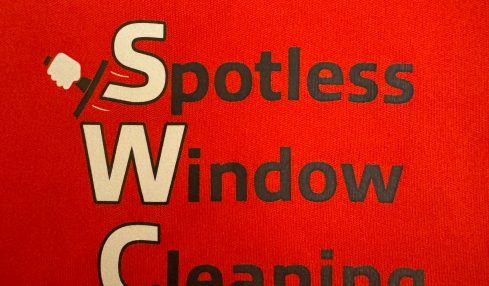Red background with black and white text reading 'Spotless Window Cleaning' and a squeegee icon.